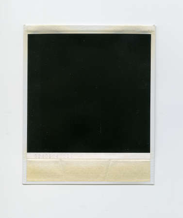 Retro vertical blank black instant aged photo frame with shadow and dust, plastic border isolated on...