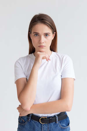 portrait of young attractive caucasian woman with long hair in t-shirt and blue jeans isolated on...
