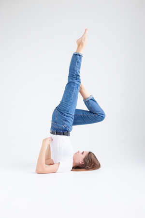 young attractive caucasian woman with long hair in t-shirt and blue jeans isolated on white...