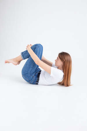 young attractive caucasian woman with long hair in t-shirt and blue jeans isolated on white...