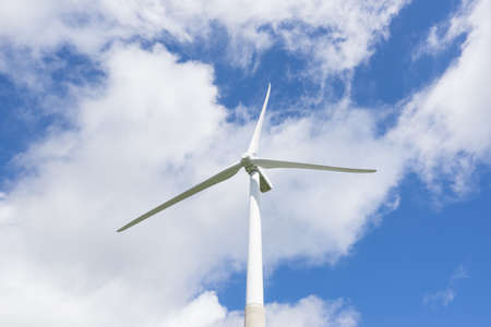 Ecology concept: Blue sky, white clouds and wind turbine. Wind generator for electricity,...