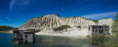 Abandoned mines and hauses. Quarry and old prison architecture. Crystal clear blue water, lake and mountain. The ashes dunes in  Estonia, Europe.の写真素材