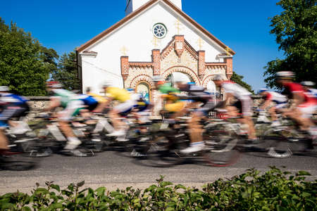 Cyclists  sports day, Orthodox Church in the background. Kihnu, small island in Estonia. Europeの写真素材