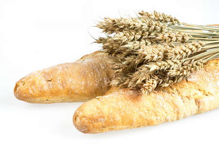 Wheat bunch and baguette isolated on white background. Grain bouquet and bread. Golden spikelets....