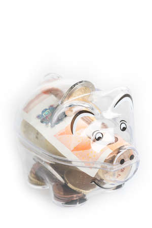 Piggy bank, coins and euro bills. Money saving concept. Banknotes closeup, isolated background.の写真素材