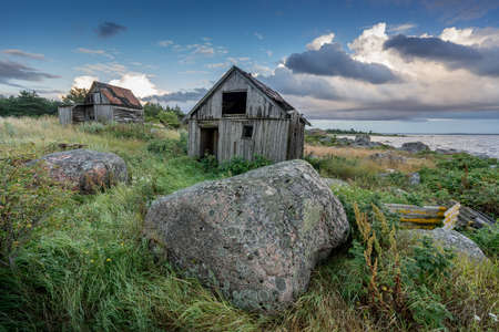 Abandoned houses in the Baltic Sea. Shore, nature and ruins facilities architecture concept. Mohni, small island in Estonia, Europe.の写真素材