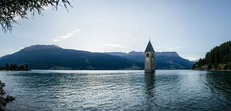 Church under water, drowned village, mountains landscape and peaks in background. Reschensee Lake Reschen Lago di Resia. Italy, Europe, SÃ¼dtirol, South Tyrol, Upper Adige, Alto Adigeの写真素材