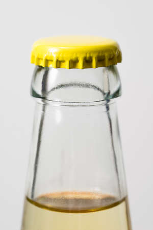 Glass bottle and yellow cap, white background.の写真素材