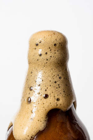 Brown glass bottle and beer, white background.