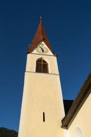 Chapel on the meadow. Bell tower, trees, shrubs and hilly green grassland. Heiliger Antoniuse church...