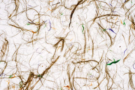 White self made paper sheet texture background. Multicolored embossed yarns, twine, lace pattern.