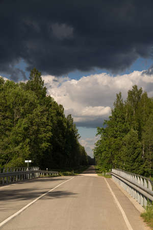 Highway to hell. Car road,  bridge and clouds of storm, natural environment  background