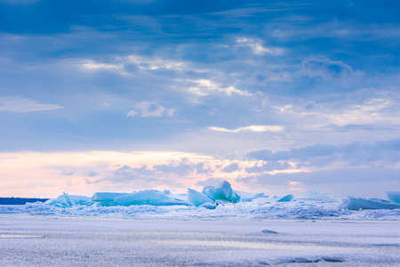 Beach in wintertime. Frozen sea, evening light and icy weather on shore like fairy tale country....