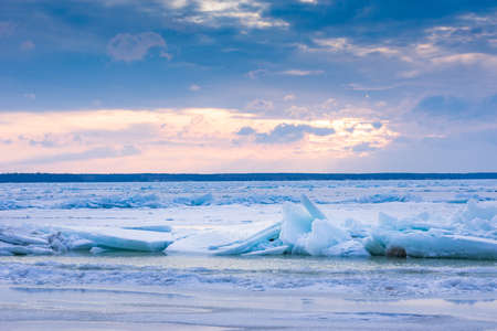 Beach in wintertime. Frozen sea, evening light and icy weather on shore like fairy tale country....