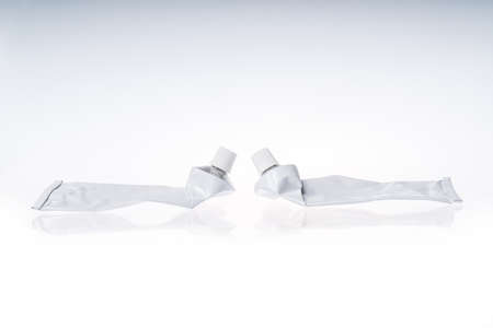 Close up of aluminum tube isolated on white background. Cosmetic or medicine gel.