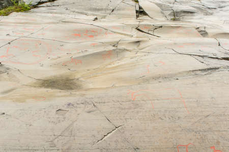 Rock art in Alta Fjord, Norway. Ancient symbols, real drawing,  texture in stone. Red ocher paint....