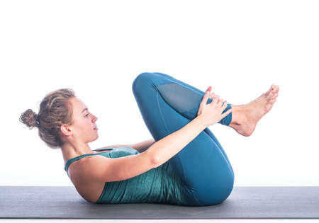 Athletic young blonde woman doing yoga practice isolated on white background. Concept of sport -...