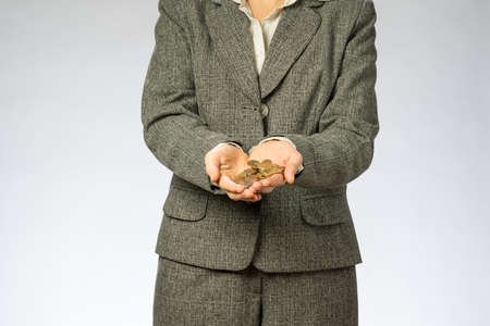 Business woman holding money in hand. European finance currency, coins.の写真素材