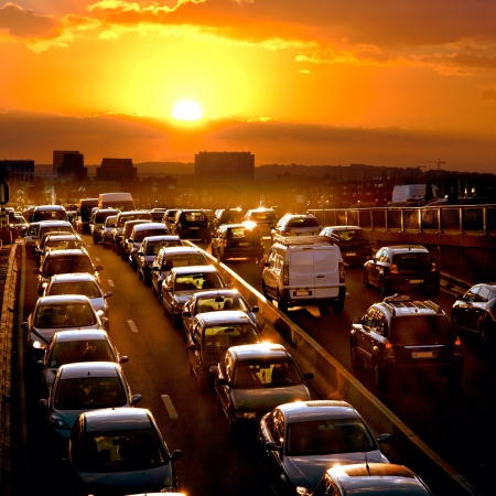 Evening traffic. The city lights. Car traffic against the sunset background.