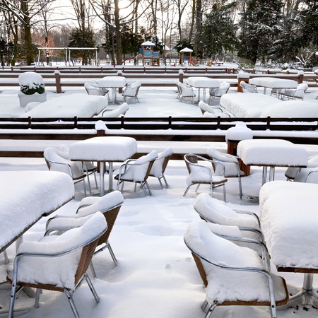 Cafe with snow  Winter landscaper  Garden furniture melting after a snowstorm の写真素材