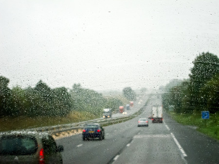 Cars on the road on a rainy day. Autumn day.の写真素材