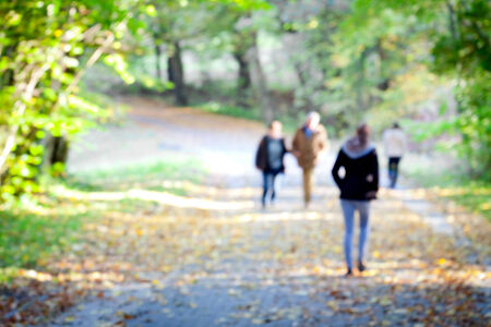 People in the autumn park. Blurred motion.の写真素材