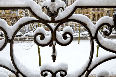 Balcony grill covered with snow. Abstract background.の写真素材