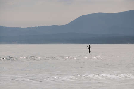 Solo paddle surfer paddling away in Alcudia Bay, Majorca winter. の写真素材