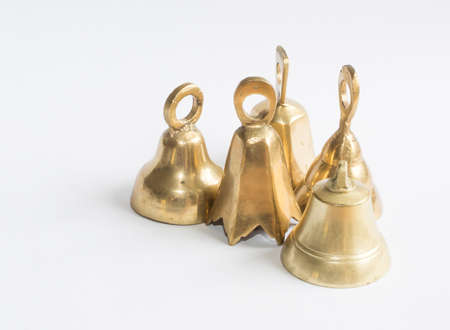 Group of brass bells on white の写真素材
