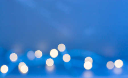 Festive blurry lights on blue background with copy spaceの写真素材