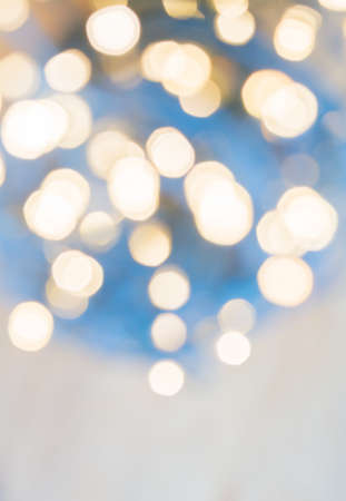 Winter lights in vertical blue and creamy white for abstract background with copy space 