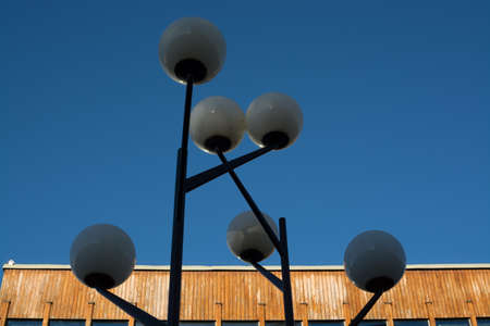 Light post in front of wood panelled building in design from the fifties in Vallingby City, suburb west of Stockholm, Sweden の写真素材