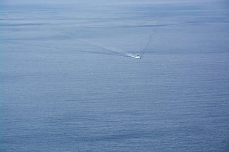 Boat on blue sea water copy space の写真素材