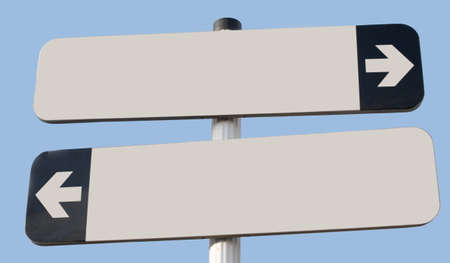 Two signs pointing in opposite direction with copy space and blue skyの写真素材