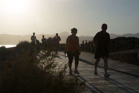 Evening walkers in Es Carnatge at summer sunset  Mallorca, Balearic islands, Spain のeditorial素材