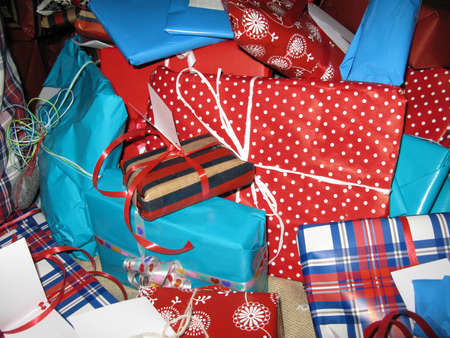 Wrapped christmas gifts with paper patterns, decors in red, white and blue.の写真素材