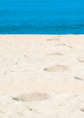 Sand tracks and footprints into the water. Mallorca, Balearic islands, Spain.の写真素材