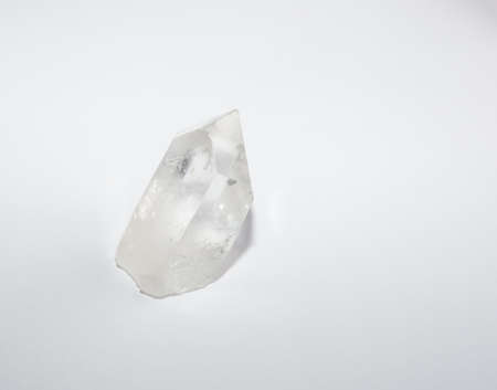 Quartz crystal point on white. Quartz crystals are said to be able to focus and intensify energy.の写真素材
