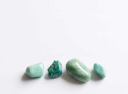 Four green semi-precious stones. Turquoise, aventurine, amazonite on white background.の写真素材