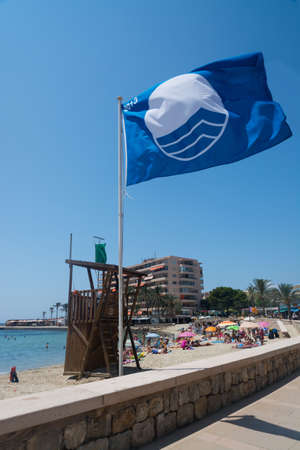 Blue flag on beach. Cala Estancia, Mallorca, Balearic islands, Spain in July.のeditorial素材