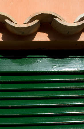 Roof tile closeup with green door for background texture.