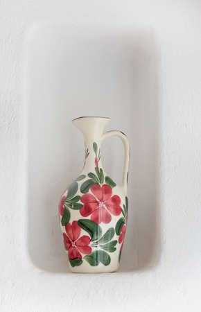 Vase flower design in red and green standing in a wall niche, Mallorca style.の写真素材