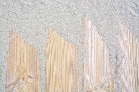 Sandy wood planks background. Closeup of boardwalk planks covered with sand in a pattern, full frame.の写真素材