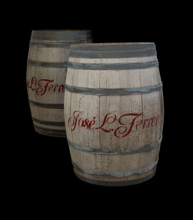 PORT DE SOLLER, MAJORCA, SPAIN - OCTOBER 25 2013: Two wine barrels from José L. Ferrer, Binissalem, Majorca, isolated on black on October 25 2013, Port de Soller, Majorca Spain.のeditorial素材