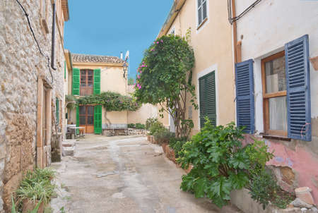 ARRACO, MAJORCA, SPAIN - OCTOBER 30 2013: Residential alley with typical buildings in drystone and green window shutters on October 30 2013 in Arraco, Mallorca, Balearic islands, Spain.のeditorial素材
