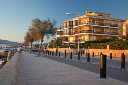 Can Pastilla, Majorca, Spain - November 6 2013: Cala Estancia street and the last rays of the sun casting light on yellow building at dusk on November 6  in Can Pastilla, Majorca, Balearic islands, Spainのeditorial素材