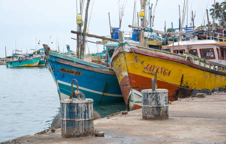 TANGALLE, SOUTHERN PROVINCE, SRI LANKA, ASIA - DECEMBER 20, 2014: Colorful wood fishing boats moored on December 20, 2014 in Tangalle port, Southern Province, Sri Lanka.のeditorial素材