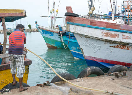 TANGALLE, SOUTHERN PROVINCE, SRI LANKA, ASIA - DECEMBER 20, 2014: Colorful wood fishing boats moored on December 20, 2014 in Tangalle port, Southern Province, Sri Lanka.のeditorial素材