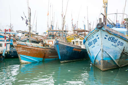 TANGALLE, SOUTHERN PROVINCE, SRI LANKA, ASIA - DECEMBER 20, 2014: Colorful wood fishing boats moored on December 20, 2014 in Tangalle port, Southern Province, Sri Lanka.のeditorial素材