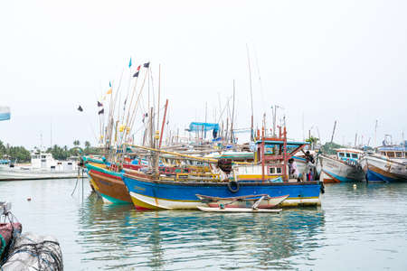 TANGALLE, SOUTHERN PROVINCE, SRI LANKA, ASIA - DECEMBER 20, 2014: Colorful wood fishing boats moored on December 20, 2014 in Tangalle port, Southern Province, Sri Lanka.のeditorial素材